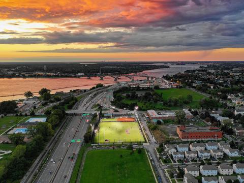 Sunset over a bridge and aerial view of campus