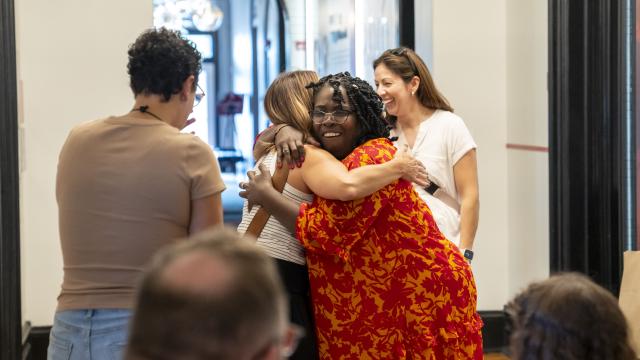 Two women hug at an Alumni Weekend event